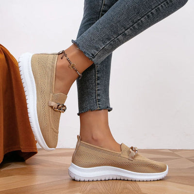 styled and breathable shoes with a gold button on top.