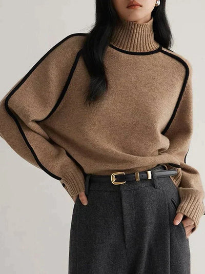 Model wears knitted brown jumper for winter with high cabbage. 