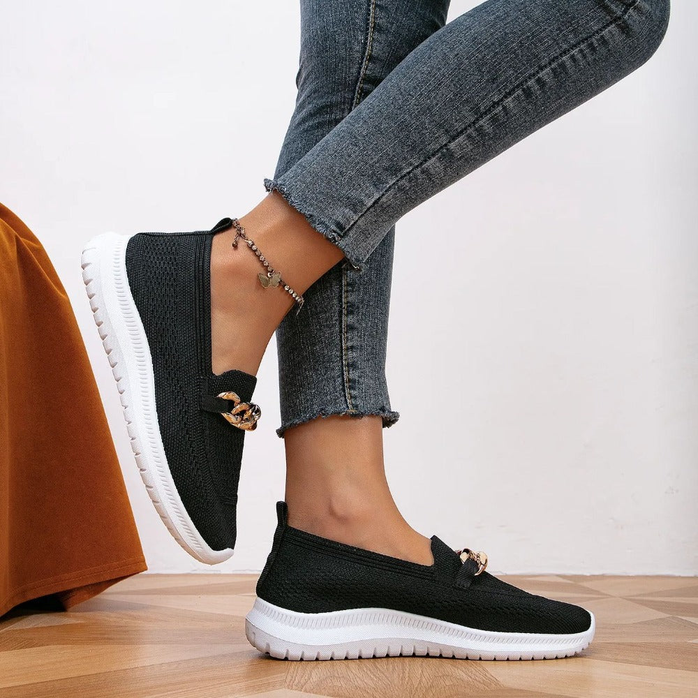 styled and breathable shoes with a gold button on top.