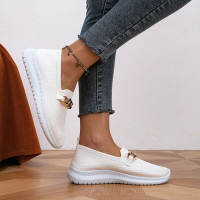 styled and breathable shoes with a gold button on top.