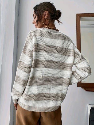 Model wears striped knitted jumper for winter.