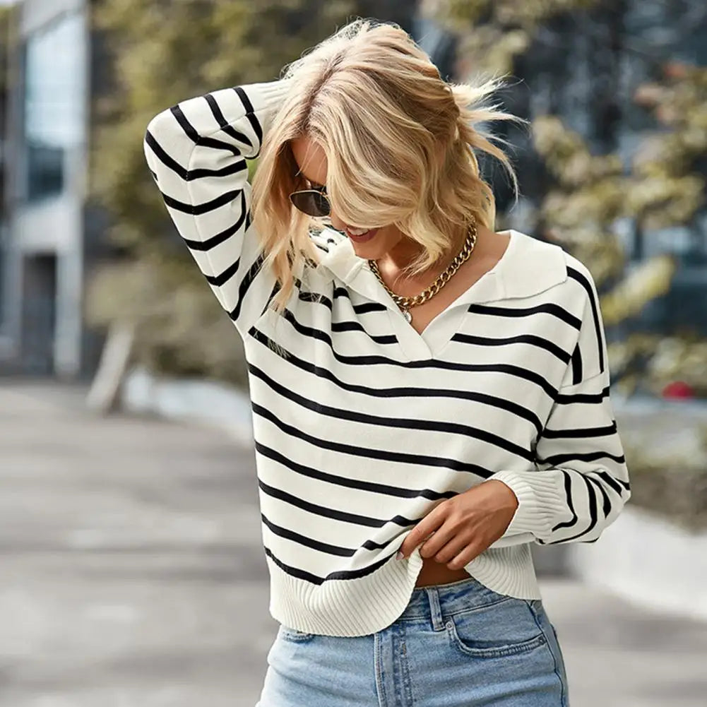 model wears long sleeve jumper with a colour in it and an open collar.