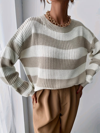 Model wears striped knitted jumper for winter.