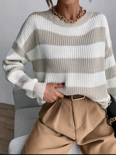 Model wears striped knitted jumper for winter.